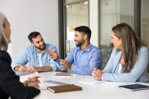Smiling business team in a meeting discussing ideas.
